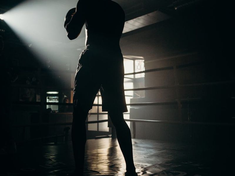 Man practicing focus exercises in a dimly lit modern room